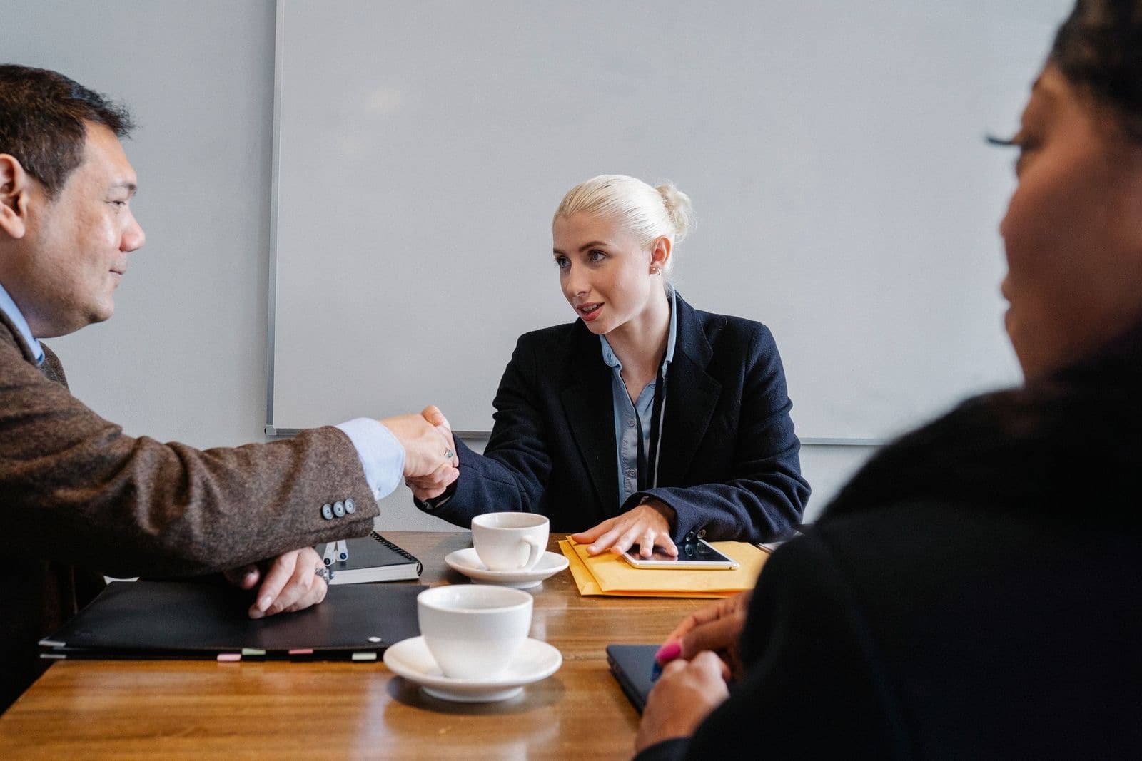 Senior colleagues in discussion around a meeting table