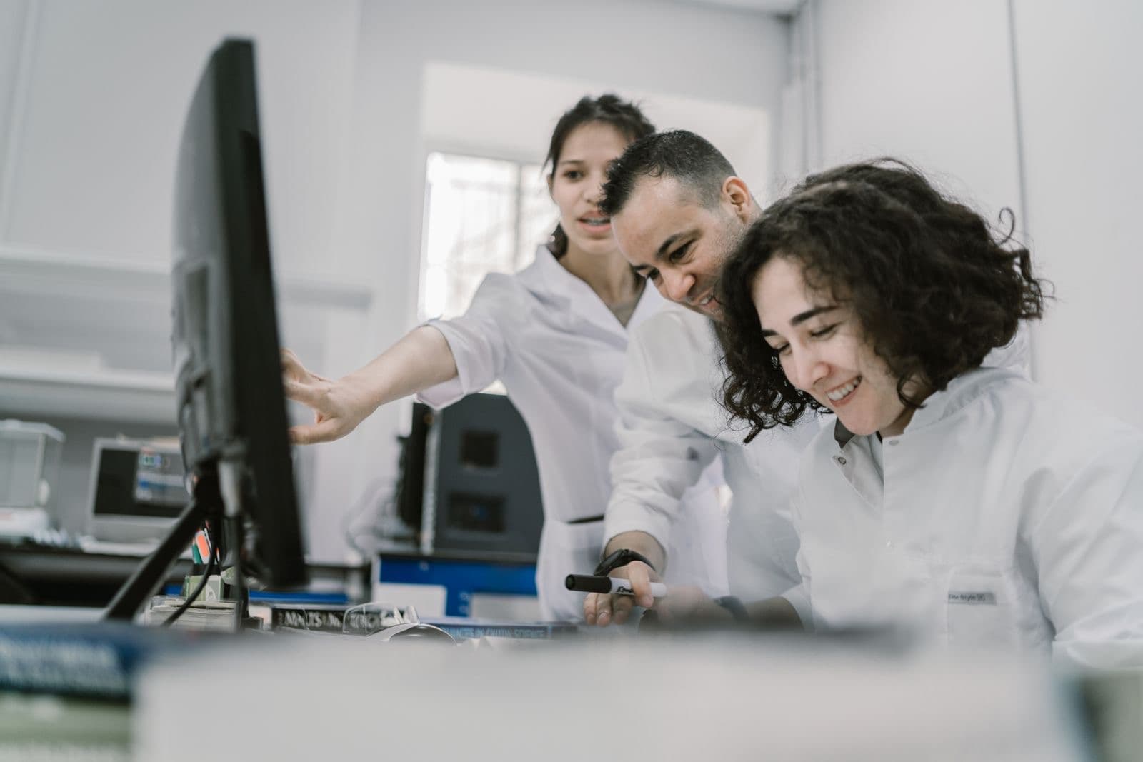 Scientists reviewing results together at a laboratory workstation
