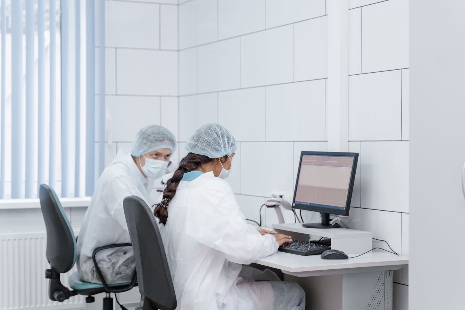 Technicians in a clean laboratory at their workstations